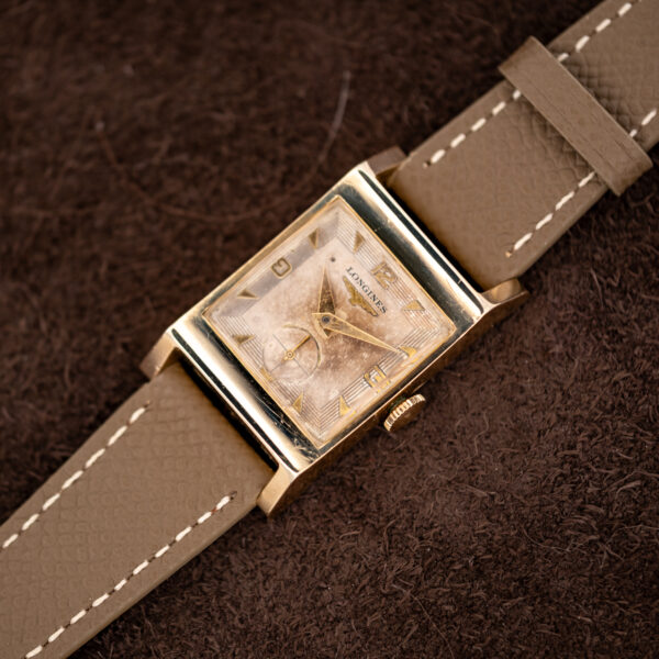Longines 2172-10 from the opposite angle, showing broad shaped lugs, eggshell dial and taupe leather strap