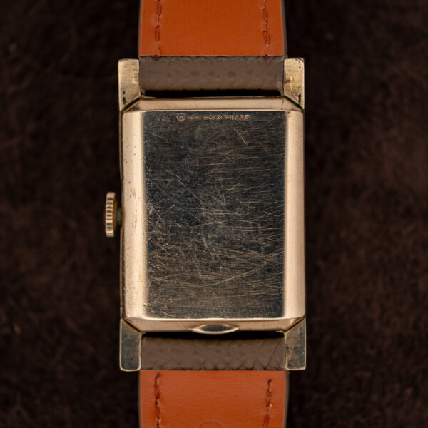 Rear view of the Longines 2172-10 showing the gold-filled caseback and orange-lined strap