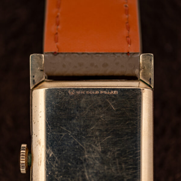 Close-up of the Longines 2172-10 caseback with a shield-like emblem and 10K GOLD FILLED stamp