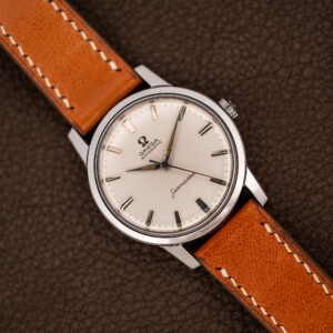 Omega Seamaster 14704 white dial seen from above, steel case on a tan strap with light stitching