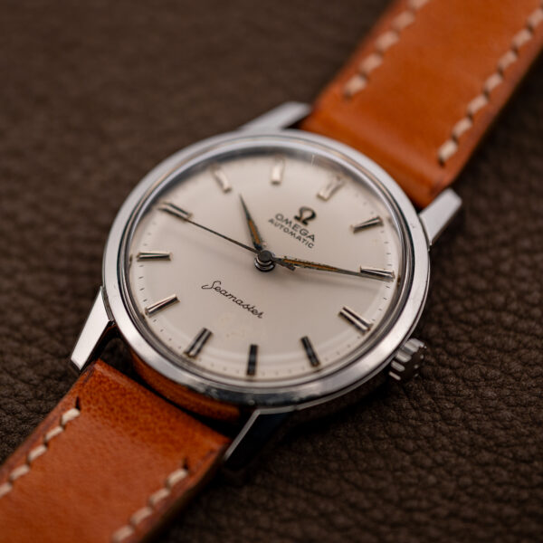 Low angle on the Omega Seamaster 14704 showing the pointed hands, domed crystal and signed crown