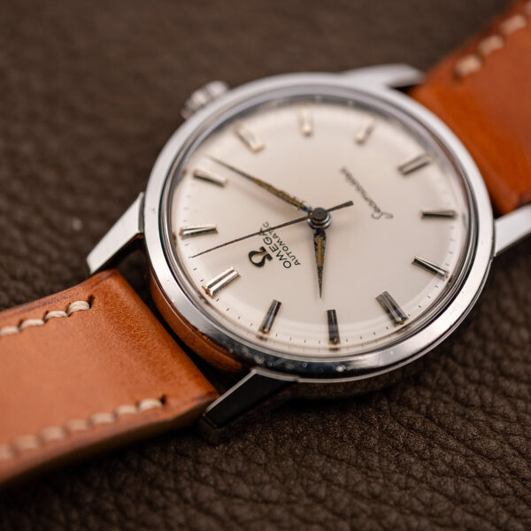 Low view from twelve o'clock across the Omega Seamaster dial, applied Omega symbol and faceted markers