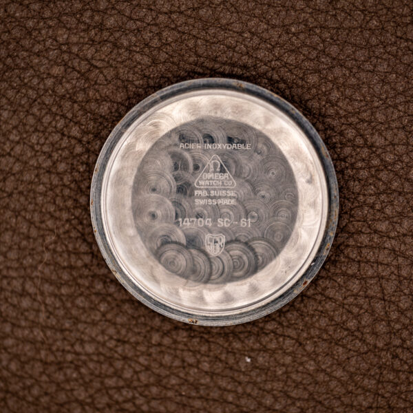 Inside caseback of the Omega Seamaster with ACIER INOXYDABLE, Omega marks and the 14704 SC-61 stamp