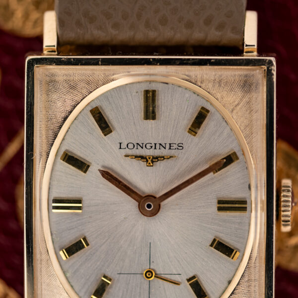 Close-up of the Longines 1137-370 upper dial with baton markers and the winged-hourglass emblem beneath the signature