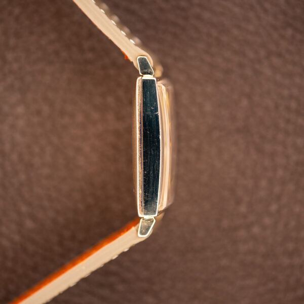 Longines tank side profile without the crown, showing the slim rectangular case, raised crystal and short lugs