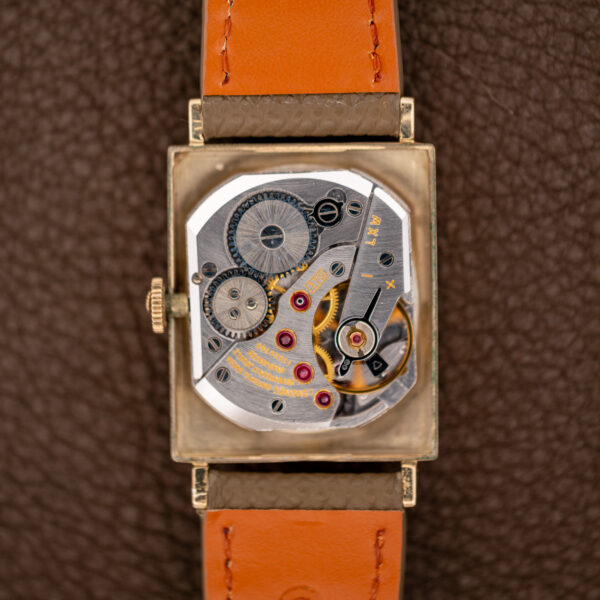 Open Longines 1137 case showing the signed manual-wind caliber 370 movement and its stamped bridge