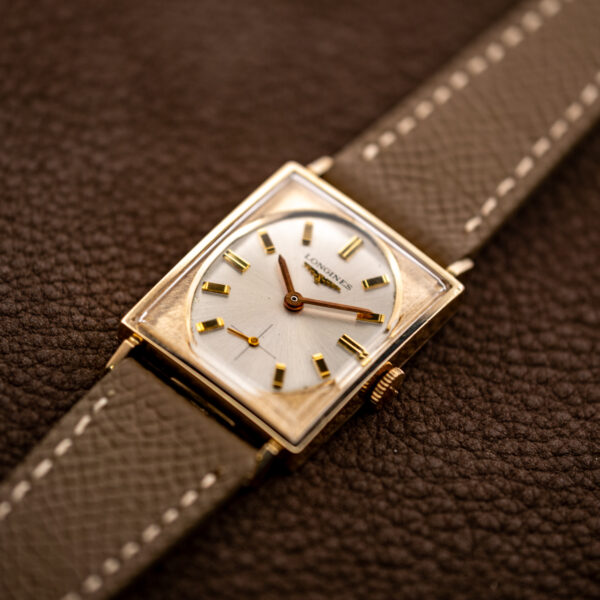 Low angled view of the Longines 1137 tank with oval dial, small seconds and taupe leather strap