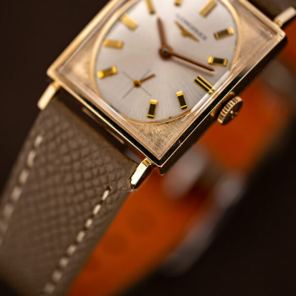 Macro of the Longines tank's textured lower corner, lug, baton markers and crosshair small seconds